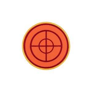 May include: A circular embroidered patch featuring a vibrant orange background with a dark red crosshair design centered in the middle. The patch is finished with a bright yellow stitched border that frames the entire circular shape.