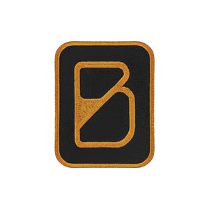 May include: A rectangular embroidered patch with rounded corners featuring a black background and a bold, golden-yellow border. Centered on the patch is a stylized letter B in the same golden-yellow thread, with a diagonal line through the center.