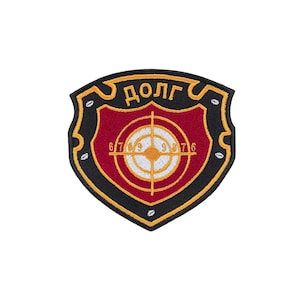May include: A shield-shaped embroidered patch with a black border, a deep red center, and gold trim. The design features a white target graphic with a crosshair and the numbers 6, 7, 8, 9, 8, 7, 6. The Cyrillic text "ДОЛГ" is stitched in gold at the top.