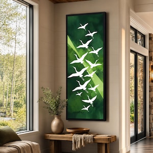 May include: A vertical rectangular wall art piece featuring a deep green watercolor-style background with a flock of white crane silhouettes flying upward. The artwork is enclosed in a thin black frame, creating a high-contrast visual display.