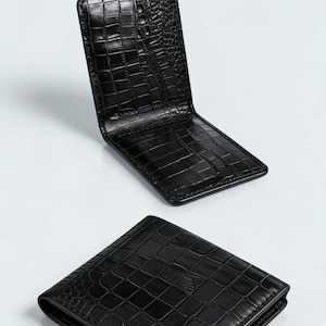 May include: A black bifold wallet with a glossy crocodile skin texture. One wallet is shown folded closed, while another is shown open. A gold-coloured circular badge in the top left corner features the text BEST CHOICE EXCLUSIVE PREMIUM QUALITY.