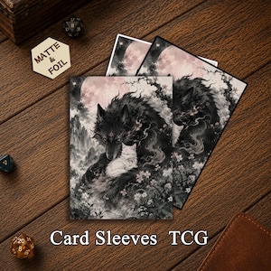 May include: Two rectangular card sleeves featuring a dark, detailed illustration of a large black wolf embracing a small white cat. The scene includes a large pale moon, misty mountains, and small pink flowers. A hexagonal tag reads MATTE & FOIL.