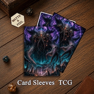 May include: Two rectangular card sleeves featuring a dark, cosmic horror illustration of a multi-eyed, tentacled creature in shades of purple and blue. The artwork depicts a monstrous entity looming over a jagged, rocky landscape with glowing accents.