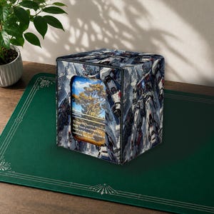 May include: A square deck box featuring a repeating graphic print of white and grey robotic figures. The front panel has a rectangular cutout displaying a trading card with an illustration of a large tree and text that reads Pay 1 life, Sacrifice Windswept Heath: Search your library for a Forest or Plains card, put it onto the battlefield, then shuffle.