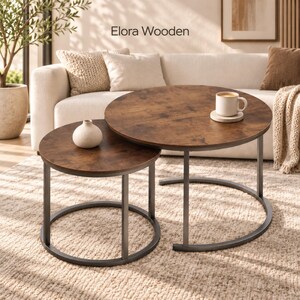 May include: A set of two round nesting coffee tables with dark brown wood-grain tops and black metal frames. The text Elora Wooden is visible above the tables. A small white ceramic vase sits on the smaller table, and a white mug sits on the larger table.