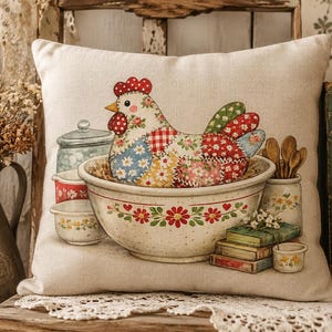 May include: A square throw pillow with a beige fabric cover featuring a printed illustration of a patchwork chicken sitting inside a large ceramic mixing bowl. The design includes small bowls, wooden spoons, and a stack of books with floral accents.