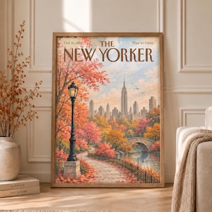 May include: A framed print of a New Yorker magazine cover dated Oct. 16, 1989, featuring an autumnal park scene with a black lamppost, a stone bridge, a pond, and the New York City skyline in the background, all rendered in warm fall colors.