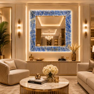 May include: A square wall mirror featuring a vibrant blue, marble-patterned frame with integrated backlighting. The mirror is mounted on a wall above a long, fluted console table, reflecting a room with a chandelier and warm ambient lighting.