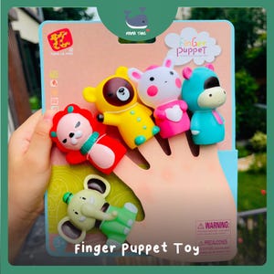 May include: A set of five colorful animal finger puppets on a cardboard display card. The puppets include a red lion, a yellow bear, a white rabbit, a blue hippo, and a green elephant. The packaging features the text Finger Puppet and Tang Le Xing.