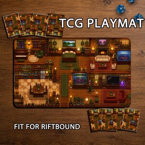 May include: A rectangular TCG playmat featuring a detailed pixel art interior of a cosy home with a kitchen, living room, bedroom, and aquarium. The text TCG PLAYMAT and FIT FOR RIFTBOUND is visible. Several blue dice are scattered on the wooden surface.