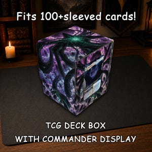 May include: A TCG deck box with a commander display featuring a dark purple and black tentacle graphic. The box includes a clear front window holding a single trading card. Text on the image reads: Fits 100+sleeved cards! TCG DECK BOX WITH COMMANDER DISPLAY.