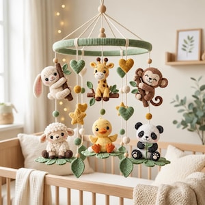 May include: A hanging nursery mobile featuring crocheted figures of a white rabbit, a yellow giraffe, a brown monkey, a white sheep, a yellow duck, and a black and white panda, all suspended from a green circular frame with yarn and wooden beads.