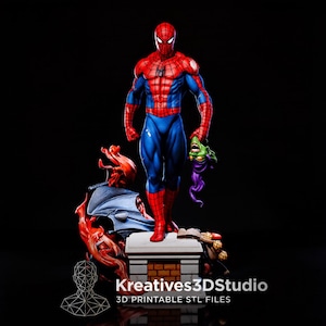 May include: A detailed figurine of Spider-Man in a red and blue suit, holding a green goblin mask. The character stands on a brick-patterned pedestal base with orange flame-like elements. Text at the bottom reads Kreatives3DStudio 3D PRINTABLE STL FILES.