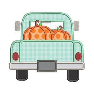 May include: An embroidered design of a vintage teal truck bed filled with three orange pumpkins. The pumpkins have brown stems and orange polka dots. The truck has a gingham pattern on the back.