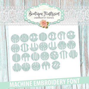May include: A set of 26 monogram letters in a circle design, in a light blue color, for machine embroidery. The letters are arranged in alphabetical order.