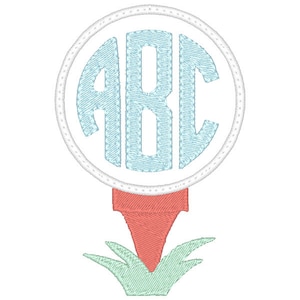 May include: A golf ball with a monogram of the letters ABC in a light blue color. The golf ball is sitting on a red golf tee with green grass.