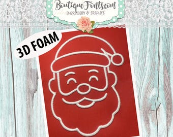 Op de afbeelding: Rode achtergrond met een wit geborduurd gezicht van de kerstman. De afbeelding bevat de tekst "3D FOAM" en "MACHINE EMBROIDERY DESIGN" in het wit. Een bloemenontwerp en de tekst "Boutique Fonts.com EMBROIDERY & GRAPHICS" staan bovenaan.