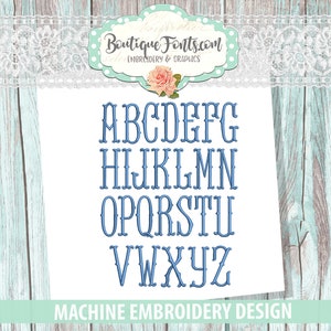Op de afbeelding: Een blauw machineborduurontwerp met het alfabet in een decoratief lettertype. De letters A t/m Z worden verticaal weergegeven. Het ontwerp bevat de tekst "Boutique Fonts.com" en "MACHINE EMBROIDERY DESIGN".