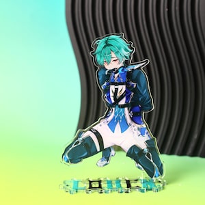 May include: An acrylic standee featuring an anime-style character with teal hair, wearing a blue and white outfit with black straps and dark blue thigh-high boots. The character is in a kneeling pose on a base with blue and black geometric patterns.