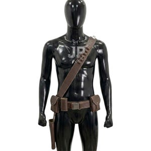 May include: A brown leather utility belt and shoulder strap set worn on a black mannequin. The gear includes a waist belt with a metal buckle, two side pouches, a holster, and a shoulder strap featuring multiple loops for small cylindrical items.