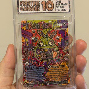 May include: A graded Trubbish trading card in a clear plastic slab. The card features a colorful, stylized illustration of a green trash bag creature with 140 HP. Text includes Gunk Shot and Trash Tidal attacks, with a Pristine Garbage 10 label.