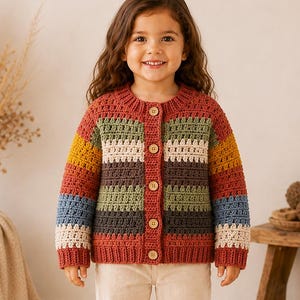 May include: A long-sleeve crochet cardigan featuring horizontal stripes in shades of rust, mustard yellow, sage green, cream, dark gray, and blue. The garment has a round neckline, a front button closure with five light-colored buttons, and ribbed cuffs.