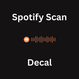 May include: A black decal featuring the white text Spotify Scan at the top and Decal at the bottom. In the center, an orange circular icon with white sound waves is followed by a series of vertical orange lines of varying heights.