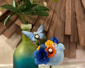 Cheerfully adorned floral ceramic bird