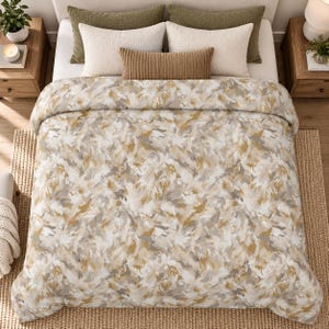 May include: A bedding set featuring a comforter with an abstract brushstroke pattern in shades of mustard yellow, gray, and white. The bed includes two large olive green pillows, two white textured pillows, and a small brown rectangular lumbar pillow.