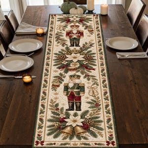 May include: A rectangular table runner featuring a cream-colored background with a repeating pattern of nutcracker figures, white poinsettia flowers, pine branches, pinecones, and gold bells, all framed by a dark green and red decorative border.