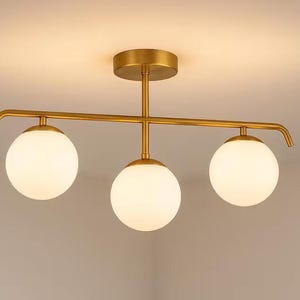 Modern brass light flush mount, opal glass globe, warm ambient light