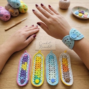 May include: A light blue crochet bracelet with a central button closure, accompanied by four additional crochet bracelets in pink, yellow, blue, and orange colorways, each featuring a button closure and the text Crochet Bracelet.
