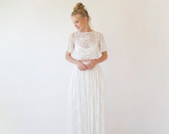 May include: A white lace crop top and matching maxi skirt. The top has short sleeves and a round neckline. The skirt is full and flowing.