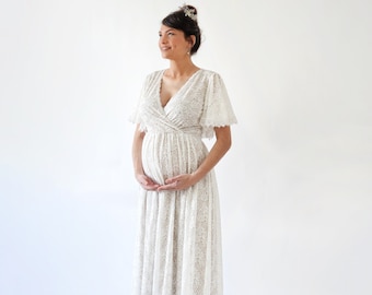 May include: A white lace maternity dress with a V-neckline and short sleeves. The dress has a fitted bodice and a flowing skirt.