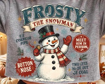 May include: A heather gray long-sleeve sweatshirt featuring a graphic of a snowman wearing a black top hat and red scarf. The text reads Frosty The Snowman, His Corncob Pipe, Button Nose, Meet Him In Person, and Two Eyes Made Out Of Coal.