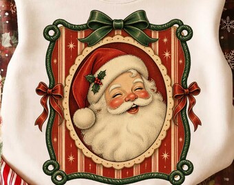 May include: A white crewneck sweatshirt featuring a central graphic of a smiling Santa Claus in a red hat with holly, framed by a decorative border with red and white stripes, green rope accents, and red bows at the sides and top.