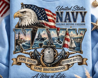 May include: A light blue sweatshirt featuring a graphic of a bald eagle, the American flag, and a naval scene. Text includes United States NAVY, Sailors Defend Freedom, Honor Courage Commitment Service, Same Ocean Different Battles, Same Brotherhood, and A Way of Life.