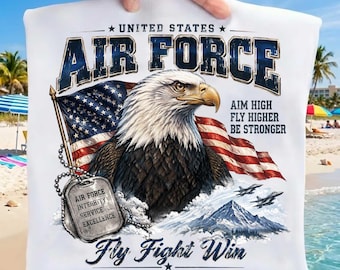 May include: A white t-shirt featuring a graphic of a bald eagle, a United States flag, and two fighter jets. The text reads United States Air Force, Aim High Fly Higher Be Stronger, Fly Fight Win, A Higher Calling, and Air Force Integrity Service Excellence.