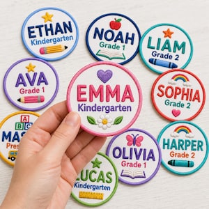 May include: A collection of circular embroidered patches featuring names like Emma, Ethan, Noah, Liam, Ava, Sophia, Harper, Olivia, and Lucas. Each patch includes grade levels such as Kindergarten, Grade 1, or Grade 2, alongside icons like pencils, books, rainbows, hearts, and flowers.