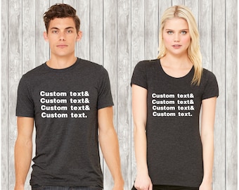 May include: Two triblend t-shirts, one crew neck and one v-neck, both in dark heather grey with white text that reads "Custom text& Custom text& Custom text. "