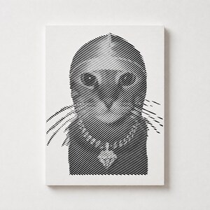 May include: A rectangular white print featuring a black line art illustration of a cat wearing a necklace. The image is composed of horizontal parallel lines of varying thickness that create the shape of the cat's head, ears, and chest.