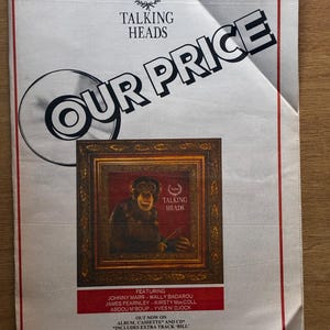 May include: A vintage 1988 New Musical Express magazine advertisement for the Talking Heads album Naked. The page features the text Our Price, a central image of a chimpanzee in a gold frame, and a list of featured artists including Johnny Marr.