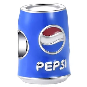 May include: A cylindrical metal charm bead shaped like a soda can, featuring a vibrant blue enamel finish. The front displays the Pepsi logo in red, white, and blue, with the word PEPSI embossed in silver lettering below the circular emblem.