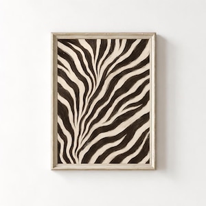 May include: A rectangular wall art print featuring a high-contrast zebra stripe pattern in dark brown and cream. The artwork is encased in a light-colored wooden frame with a visible grain, presenting a vertical orientation and abstract design.