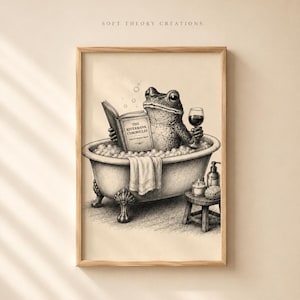 May include: A black and white illustration of a frog sitting in a clawfoot bathtub filled with bubbles. The frog holds a book titled The Riverbank Chronicles and a glass of wine. A small wooden stool with a candle and bottle sits nearby.