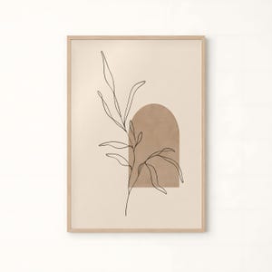 以下が含まれることがあります： 薄いベージュの背景に、茶色のアーチ型と黒い線画の植物の枝が描かれた額装されたウォールアートプリント。作品は、シンプルな明るい色の木製フレームに収められており、縁はすっきりとしたデザインになっています。
