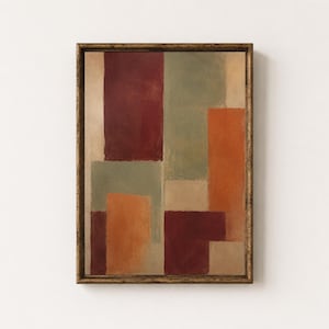 Puede incluir: Una pintura abstracta enmarcada que presenta una composición de bloques rectangulares en tonos burdeos intenso, verde salvia apagado, naranja quemado y beige. La obra está encerrada en un marco de metal dorado oscuro texturizado y envejecido.