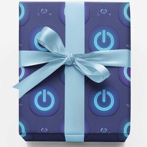 May include: A rectangular gift box wrapped in dark blue paper featuring a repeating pattern of glowing light blue power symbols. The package is tied with a smooth, light blue satin ribbon that is knotted into a bow at the center of the box.