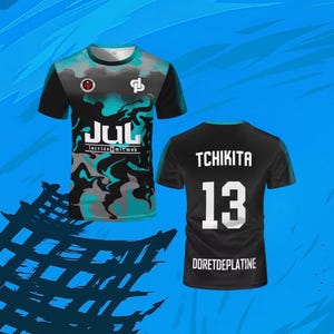 May include: A short-sleeve t-shirt featuring a black, teal, and gray marbled pattern on the front with the text JUL and lacrizeomicmak. The back is solid black with the white text TCHIKITA, the number 13, and the text DORETDEPLATINE at the bottom.