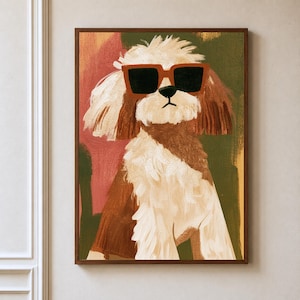 May include: A framed wall art print featuring a stylised painting of a fluffy dog with white and brown fur. The dog is wearing large, square, orange-rimmed sunglasses with dark lenses. The background consists of abstract blocks of pink and olive green.